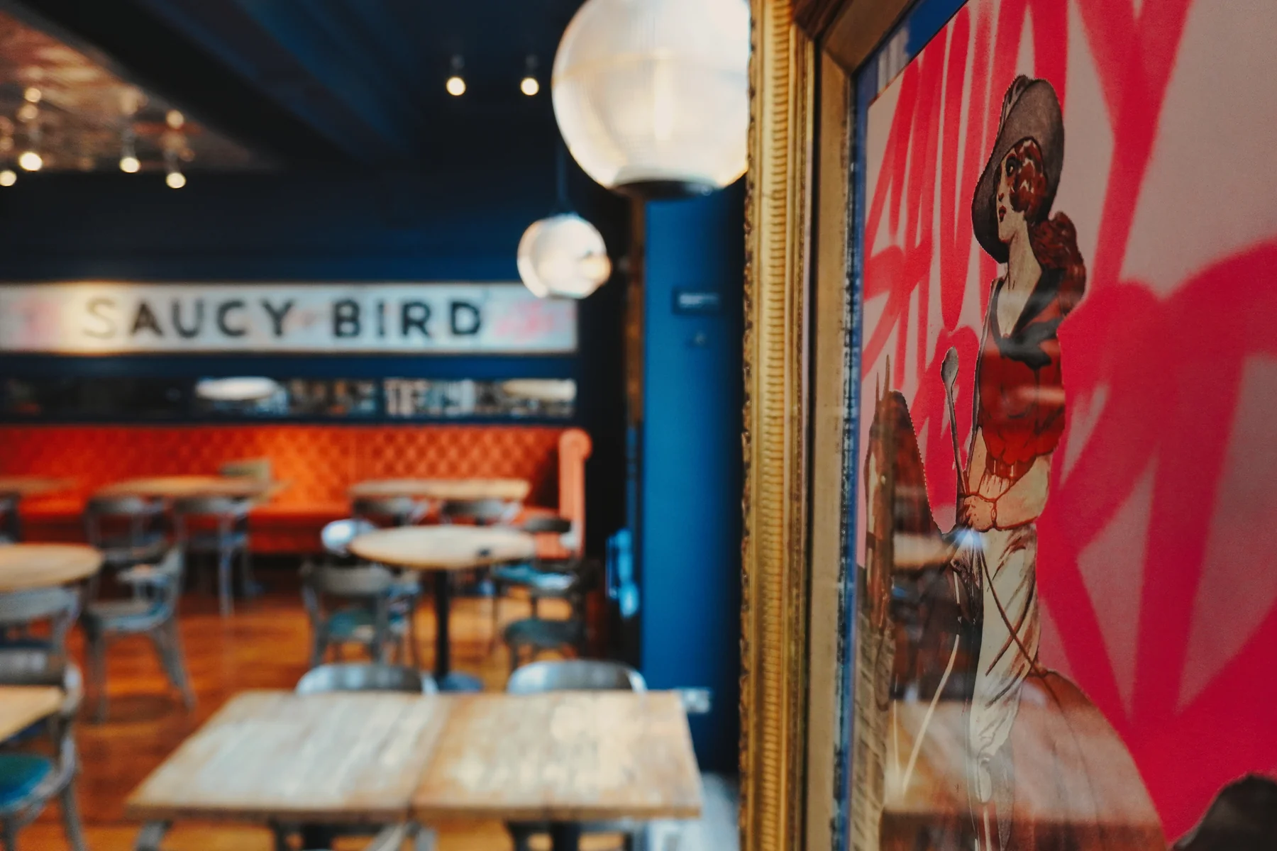 Saucy Bird artwork beside the dining room and windows