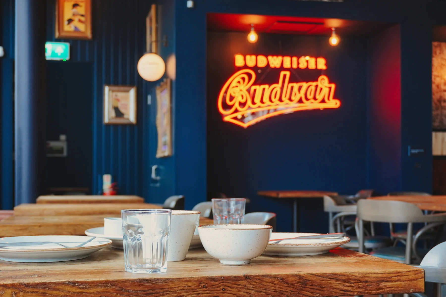 Close view of the table setting beneath the illuminated brewery sign